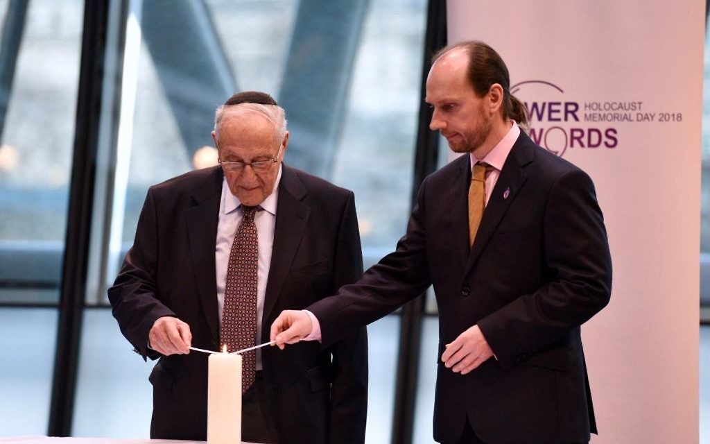 Holocaust survivor Manfred Goldberg  and Kemal Pervanic, a survivor of the Bosnian genocide, light a memorial candle