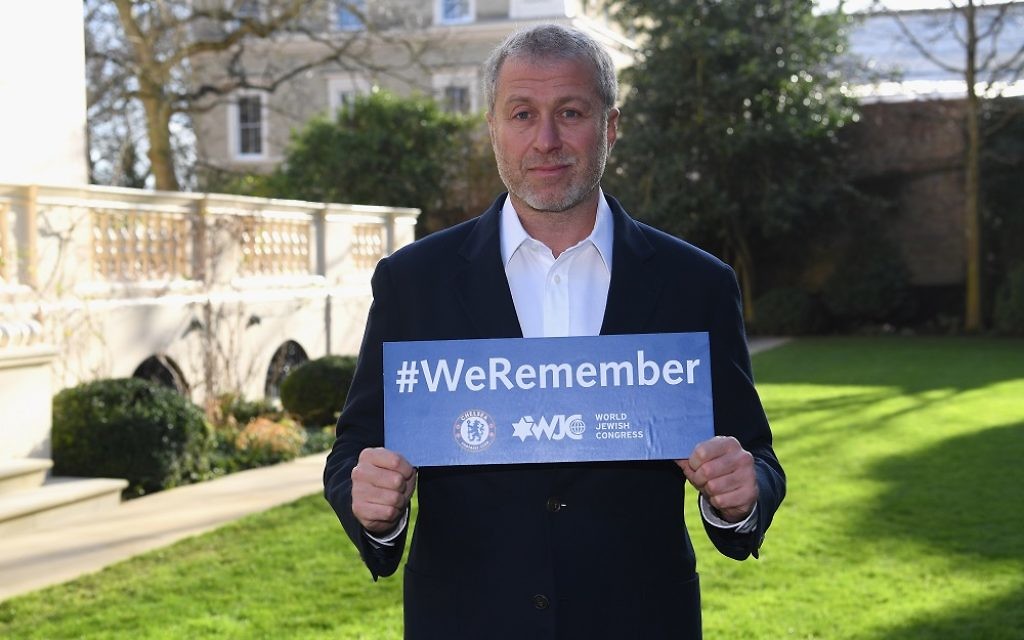 Chelsea owner Roman Abramovich with a 'We Remember' sign after International Holocaust Remembrance Day in 2018