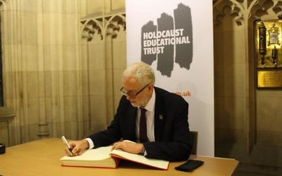 Jeremy Corbyn signing the Holocaust Educational Trust's book of commitment last year.