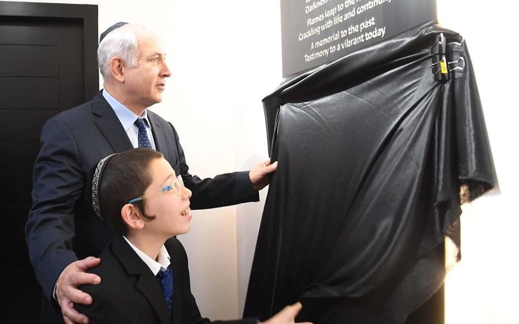 Prime Minister Benjamin Netanyahu with Moshe Holtzberg, son of the victims killed in the attack, at a memorial ceremony for the victims at the Chabad House in Mumbai.
Photo: Avi Ohayon, GPO