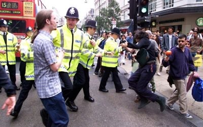 Police lead away a protester outside in central London calling for an end to the sale of goods from Israeli settlements.