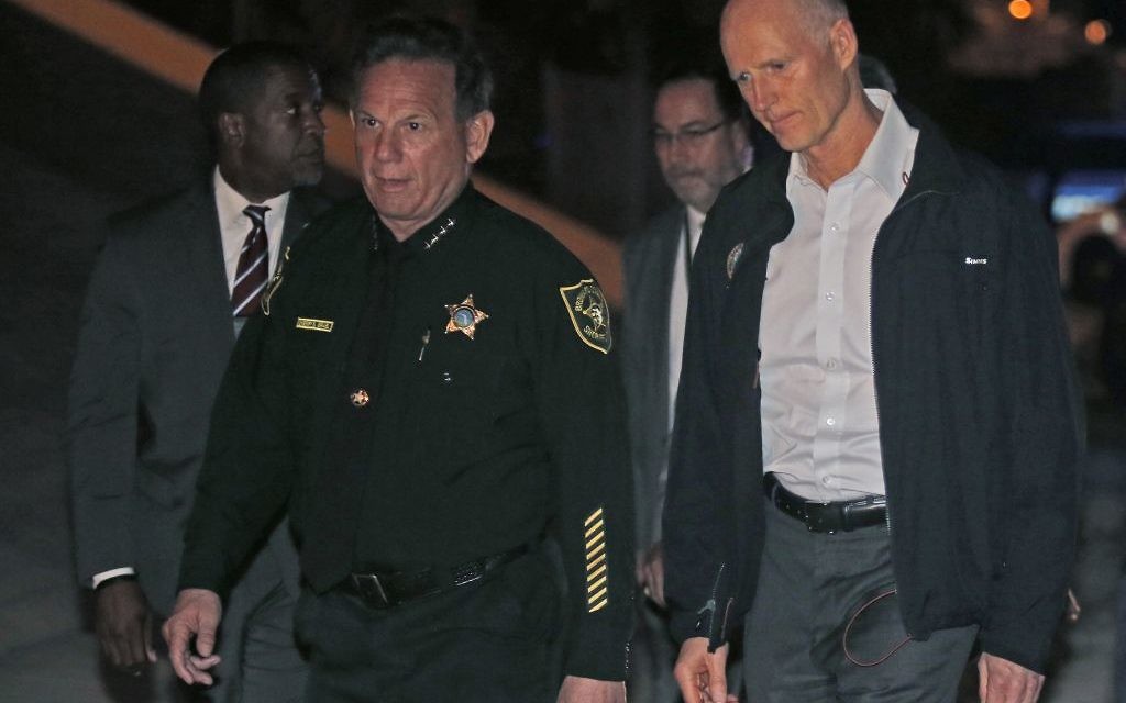 Florida Gov. Rick Scott, right, walks with Sheriff Scott Israel of Broward County to a news conference near Marjory Stoneman Douglas High School in Parkland, Fla., (AP Photo/Wilfredo Lee)