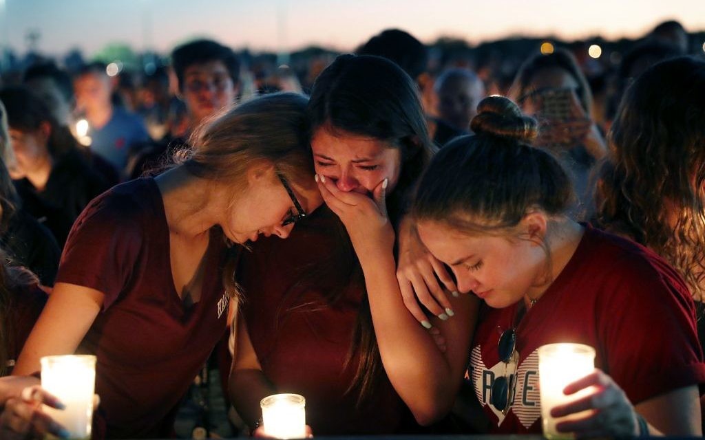 Students console each other as they weep during a candlelight vigil for the victims of the Wednesday shooting at Marjory Stoneman Douglas High School, in Parkland, Fla., 

(AP Photo/Gerald Herbert)