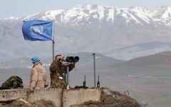 Members of the United Nations Disengagement Observer Force (UNDOF) looks through binoculars at Mount Bental, an observation post in the Israeli occupied Golan Heights near the ceasefire line between Israel and Syria February 9, 2018. Photo by: JINIPIX