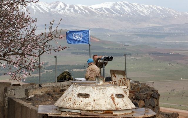 Members of the United Nations Disengagement Observer Force (UNDOF) looks through binoculars at an observation post in the Golan Heights Photo by: JINIPIX