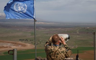 Members of the United Nations Disengagement Observer Force (UNDOF) looks through binoculars at Mount Bental, an observation post in the Israeli occupied Golan Heights near the ceasefire line between Israel and Syria February 9, 2018. Photo by: JINIPIX