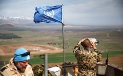 Members of the United Nations Disengagement Observer Force (UNDOF) looks through binoculars at an observation post in the Golan Heights Photo by: JINIPIX