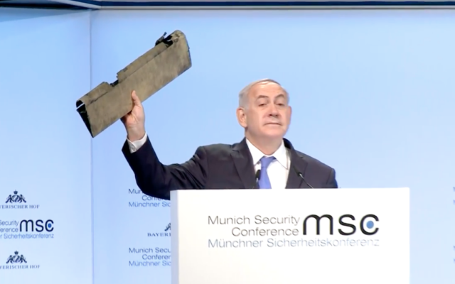Benjamin Netanyahu holds a piece of Iranian drone that Israel shot down at the Munich security conference