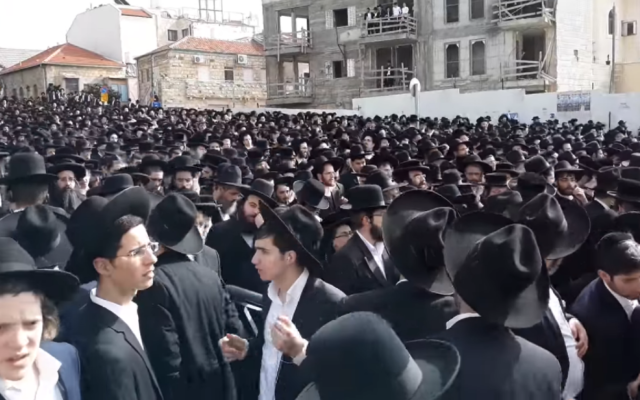 Screenshot from video of mourners at the funeral procession for Shmuel Auerbach,