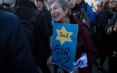 Naomi Wimborne-Idrissi, of Jewish Voice for Labour holds up a sign at the #EnoughIsEnough Demonstration against antixemitism, featuring a yellow star and the word Jews

Photo Credit: Marc Morris