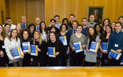 Graduates of the programme holding their certificates at ceremony in parliament