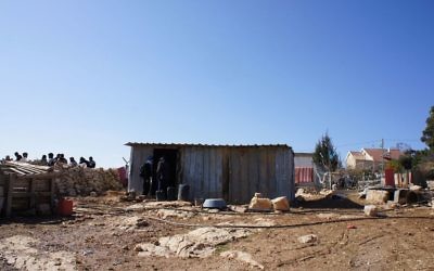 The rubble of a home demolished by the IDF, with a tin shack that a family now has to live in, in Umm al-Khair.