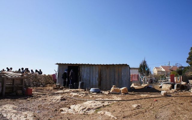 The rubble of a home demolished by the IDF, with a tin shack that a family now has to live in, in Umm al-Khair.