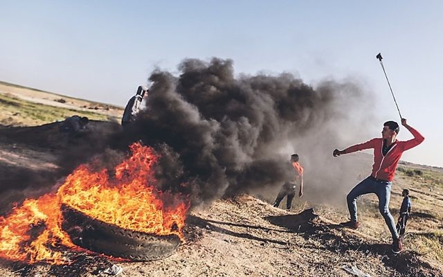 Protesters run during clashes with Israeli security forces following a demonstration near the border with Israel in the southern Gaza Strip 

(Photo by Momen Faiz/NurPhoto/Sipa USA)