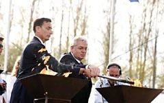 Aaron G. Frenkel and Matthew Bronfman light a torch. credit Yossi Zeliger