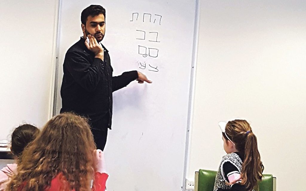 Zain teaches pupils the Hebrew alphabet at the Wimbledon cheder