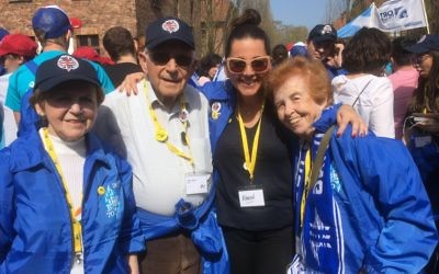 Karen Pollock of the  (second from right) with survivors Mala Tribich , Eve Kugler, Harry Olmer, at Auschwitz during March of the Living in 2018.