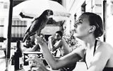 Shelagh Wilson with a parrot, Copacabana beach, 1951
