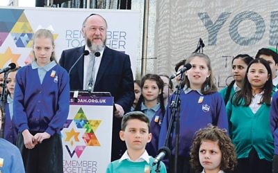 Chief Rabbi Ephraim Mirvis at 2018's Yom Hashoah ceremony with a  school choir in the background.