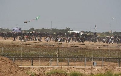 Palestinians try to use a kite to fly a Molotov Cocktail toward IDF troops along the Gaza fence on April 13 2018. (Israel Defense Forces)