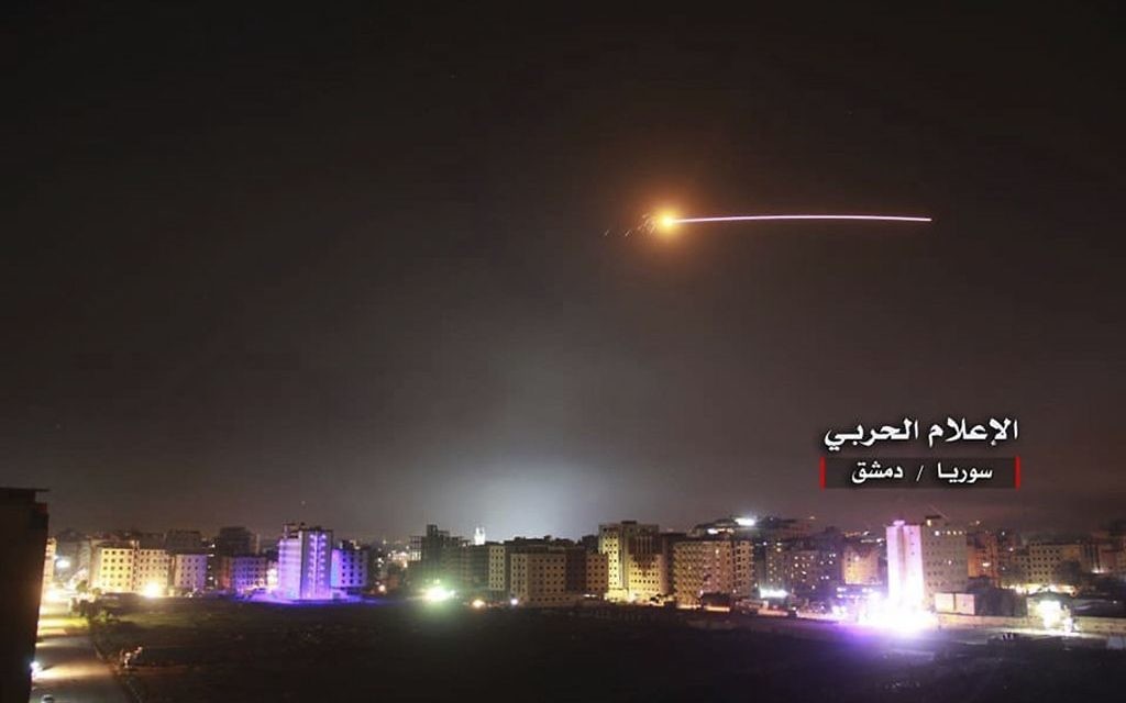 Photo provided by the government-controlled Syrian Central Military Media, shows missiles rise into the sky as Israeli missiles hit air defense position and other military bases, in Damascus, Syria, in May 2018.   (Syrian Central Military Media, via AP)