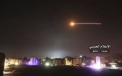Photo provided by the government-controlled Syrian Central Military Media, shows missiles rise into the sky as Israeli missiles hit air defense position and other military bases, in Damascus, Syria, in May 2018.   (Syrian Central Military Media, via AP)