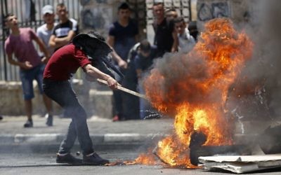 Palestinians burn tires during clashes with Israeli forces n the West Bank city of Bethlehem, Tuesday, May 15, 2018. (AP Photo/Majdi Mohammed)