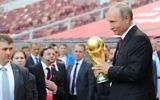 Russian president Vladimir Putin holding the FIFA World Cup Trophy at a pre-tournament ceremony in Moscow, September 2017