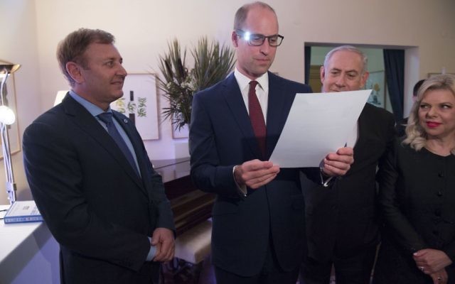 The Duke of Cambridge (centre), with Israeli Prime Minister Benjamin Netanyahu (right) and inventor Ziv Aviram (left) as he tries on glasses linked to a computer to help partially sighted people to see more clearly, during a Garden reception at the UK Ambassador to Israel in Tel Aviv, Israel 

Photo credit : Arthur Edwards/The Sun/PA Wire