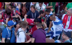 Morocco fans try to rip away an Israeli flag during their game versus Portugal