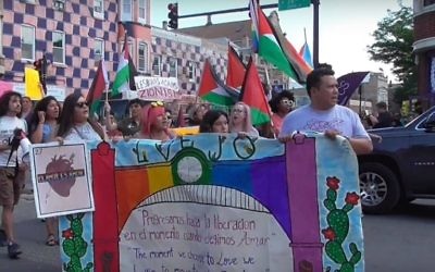 Participants in the 2018 Chicago Dyke March waving Palestinian flags. (Screenshot of Windy City Times video)