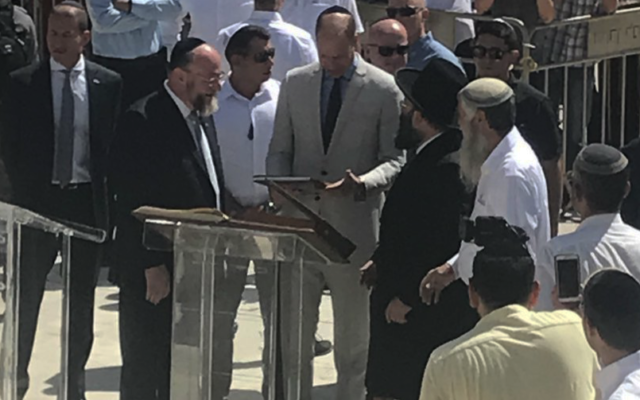 Prince WIlliam alongside the Chief Rabbi (left) praying at the Western Wall
