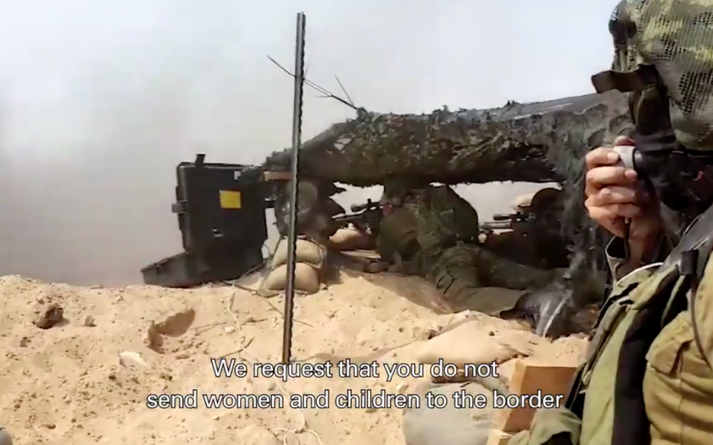 IDF soldier on the border uses a megaphone to speak to Gaza's on the border in Arabic, urging them not to approach the fence