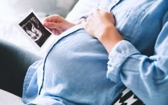 Pregnant woman looks at a scan