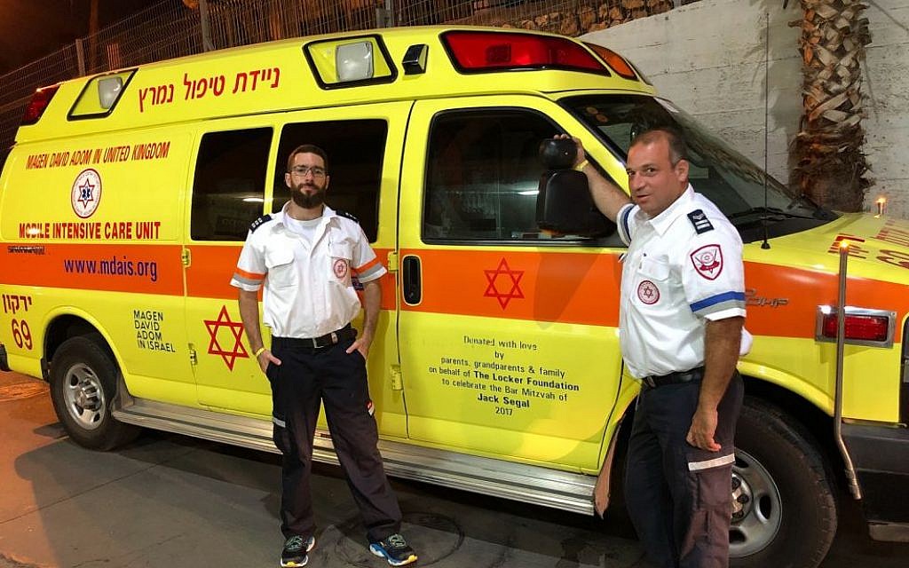 MDA staff in Israel with one of their ambulances
