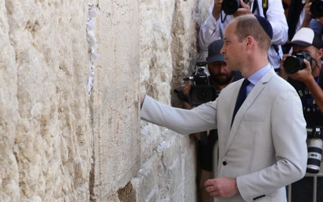 Moment of reflection: The prince places a private note in the Western Wall.