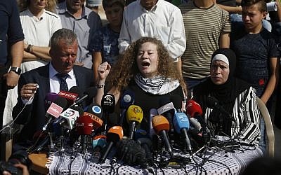 Ahed Tamimi speaks sitting between her father Bassam and mother Nariman during a press conference on the outskirts of the West Bank village of Nabi Saleh near the West Bank city of Ramallah,

(AP Photo/Majdi Mohammed)