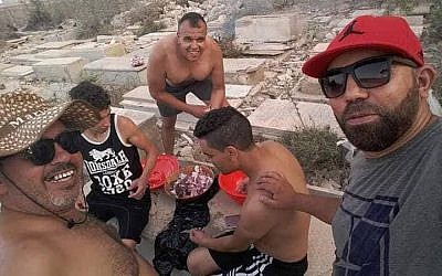 Men having a barbecue in the Sousse Jewish cemetery. Credit: Elie Trabelsi on Facebook