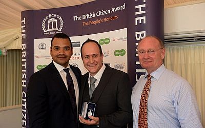 Dr Asher Lewinsohn (centre) collects his award, flanked by TV presenter and awards host Michael Underwood (left) and BCA Ambassador Des Benjamin (right)