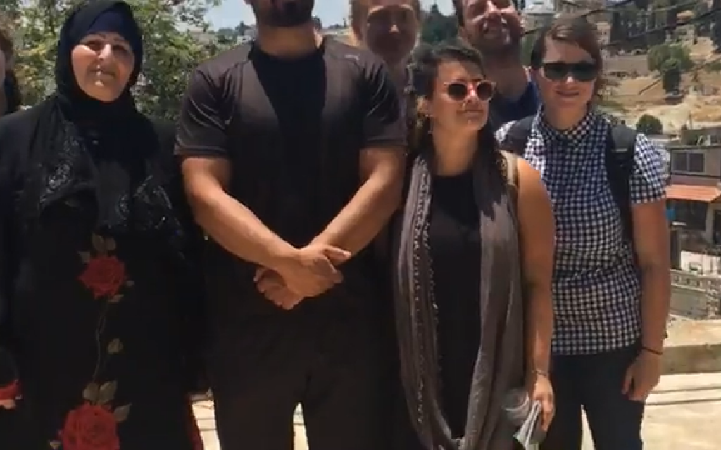 Left-wing Birthright participants with a family of Palestinians who are to be evicted from their house