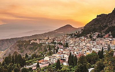 Taormina city and Etna volcano during a dramatic sunset in Sicily, Italy