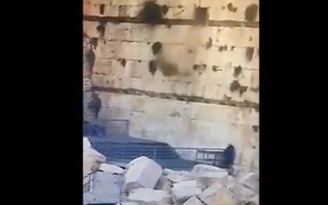 Screenshot shows video footage of the boulder dropping from the Kotel