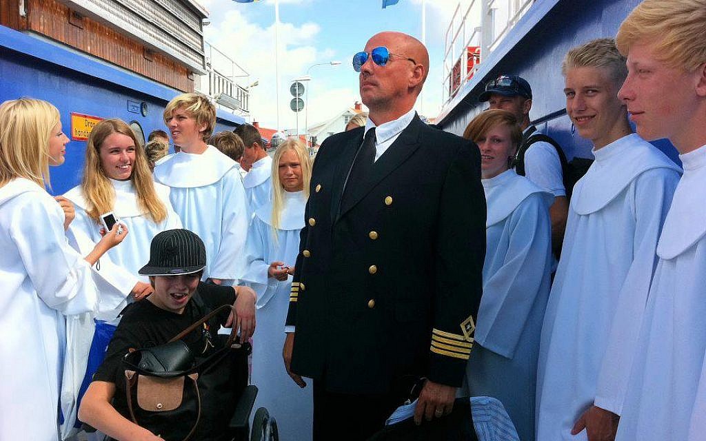 Stefan Abrahamsson with his yacht, in uniform