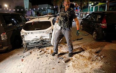 Israeli security cleans up the aftermath of a Palestinian rocket attack (Source: IDF spokesperson)