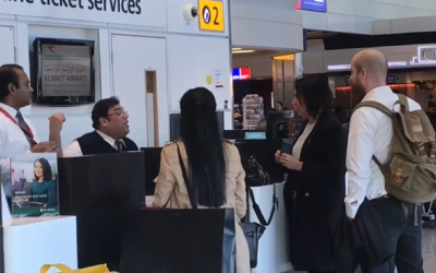 Guests at at a Kuwait Airlines desk at Heathrow, being refused on to the plane
