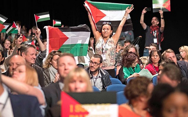 Delegates wave Palestinian flags at the Labour Party's annual conference in 2018. Photo credit: Stefan Rousseau/PA Wire