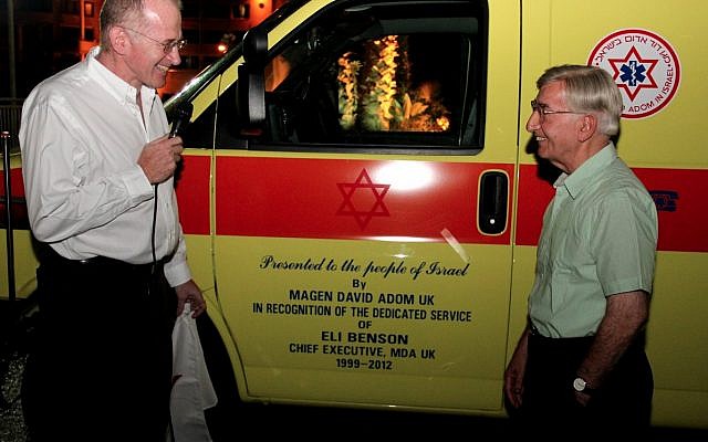 Eli Benson (right) with an ambulance dedicated in his name