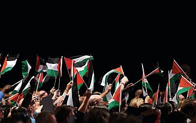 Delegates hold up Palestinian flags during a debate on the third day of the Labour party conference in Liverpool, September 2018  (Photo creditOLI SCARFF/AFP/Getty Images)