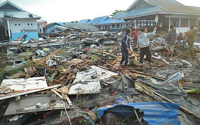 People survey the damage following a massive earthquake and tsunami in Palu, Central Sulawesi, Indonesia (AP Photo/Rifki)