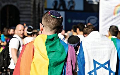 Keshet UK Pride picture from 2017, with a Jewish member of the march wearing a kippah, alongside another with an Israel flag. (Jewish News)